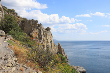 Rocky mountains on the Black Sea coast in Crimea. The new world. Blue sky over the summer sea. Calm sea water
