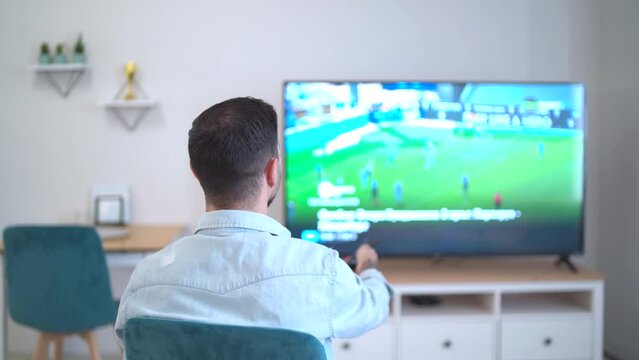 football fan changing tv watching soccer in qatar at home