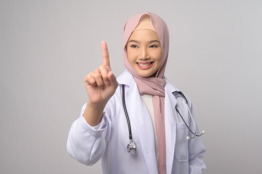 Portrait of muslim female confident doctor over white background studio, healthcare and Medical technology concept.