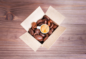 Small shipping box with coffee beans and a cup
