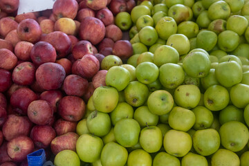 Buying organic food at the farmers' market. Fresh apples on the counter