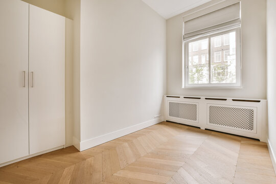 Empty room with whitewash walls and built in wardrobe