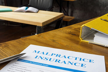 Table with Malpractice insurance application on it.