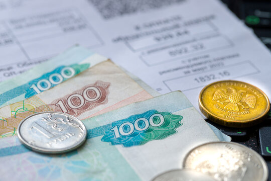 Russian coins and banknotes , pen and receipts for payment on the table