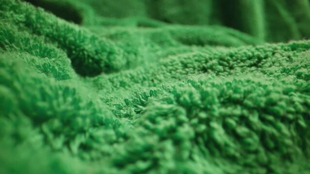 Texture of green soft terry towel textile.