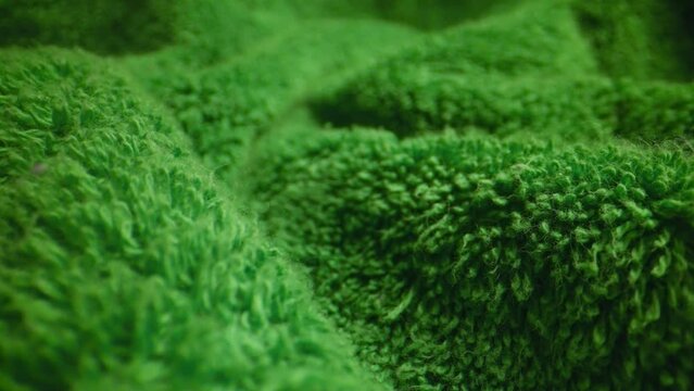 Texture of green soft terry towel textile.