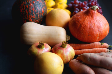 Various fresh and healthy autumnal fruit and vegetable. Selective focus, dark background.