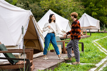 A couple entering a tent at glamping