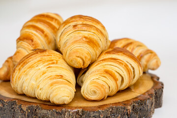 Delicious breakfast with fresh croissants and coffee served with butter and honey.