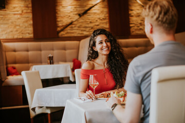 Young couple having lunch with white wine in the restaurant