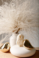 christmas decoration with white candle owl and dry grass
