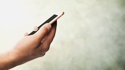 Person's Hand with modern new Smartphone and blank screen.