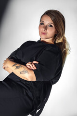 Fototapeta premium Photos of a beautiful girl in the studio under different lighting schemes. Suitable for covers and advertisements