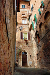 Fototapeta na wymiar A steep lane, Via di Castelvecchio, Contrada della Tartuca, Siena, Tuscany, Italy