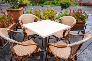 table with wicker chairs of a street cafe