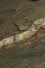 Photo of the texture of natural stone. The heterogeneous background of dark stone