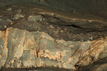 Photo of the texture of natural stone. The heterogeneous background of dark stone