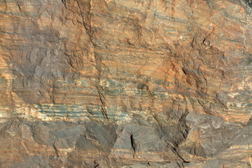 Photo of the texture of natural stone. The heterogeneous background of dark stone