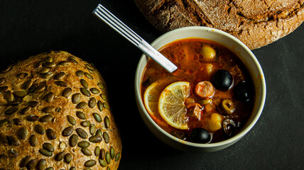 Cup of soup with pumpkin bread with seeds