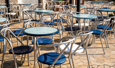 tables with blue chairs of a street cafe