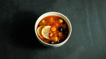 Solyanka soup with olive and lemon