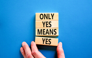 Only yes means yes symbol. Concept words Only yes means yes on wooden blocks on a beautiful blue table blue background. Businessman hand. Business, psychological only yes means yes concept.