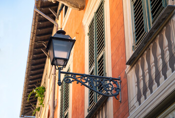Antique street lamp on the wall of the house