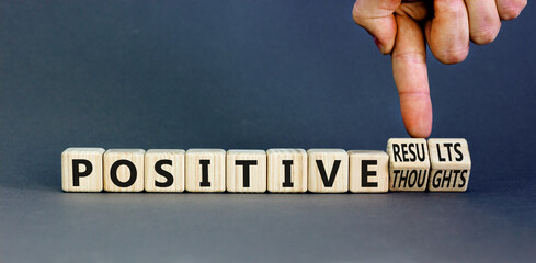 Positive results thoughts symbol. Concept words Positive results or Positive thoughts on cubes. Businessman hand. Beautiful grey background. Business positive results and thoughts concept. Copy space