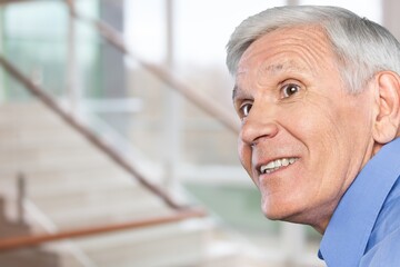 happy old man smiling at home interior