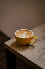 Vertical close-up shot of a cappuccino in a cup