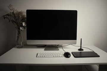 Comfortable place of work. Close-up top view of comfortable working place in office with and laptop. Workplace of designer.