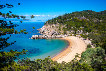 Fototapeta na wymiar aerial view of paradise beach with turquoise water on magnetic island, small paradise bay surrounded by rocks, beach holiday in queensland, australia
