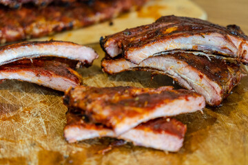 Сutted tasty smoked pork ribs on wooden desk