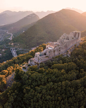 Aerial view of Arechi castle on hilltop with Mediterranean Sea in background during sunset, Salerno, Italy.