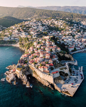 Aerial view of Ulcinj, a small town on a rocky promontory along the Mediterranean coastline in Montenegro during sunset.