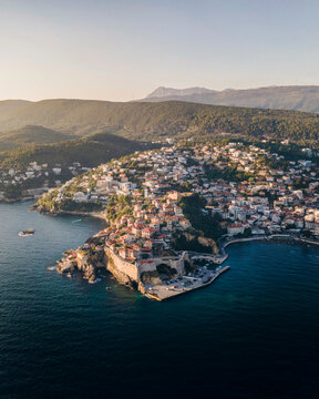 Aerial view of Ulcinj, a small town on a rocky promontory along the Mediterranean coastline in Montenegro during sunset.