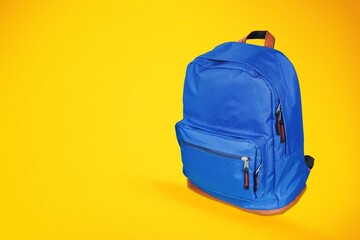 Modern colored school backpack on yellow background