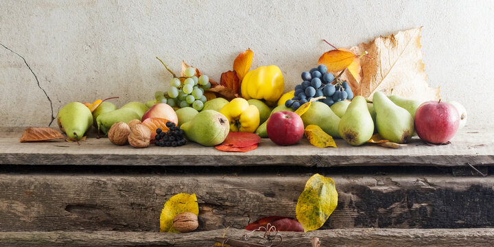 rural harvest on the wooden board. bunch of ripe fruits. organic healthy food and rustic still life composition