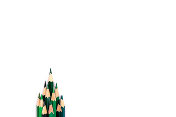 A creative Christmas tree made of green pencils on a white background.Christmas and New Year flat...