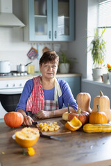 elderly woman cooking pumpkin