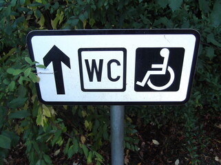 Disabled toilet sign with directional in black and white  - 537073531