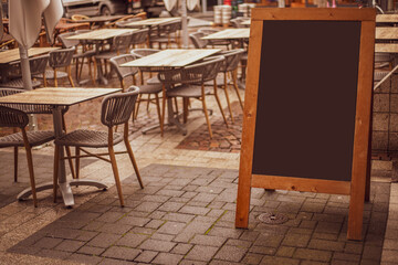 Fototapeta na wymiar Empty sandwich chalkboard stand on a street ready to be filled