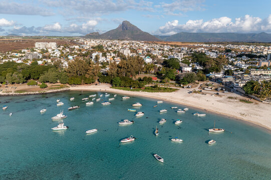 Panoramic aerial view of a bay with anchored boats and a mountain the background, Flic en Flac, Mauritius.