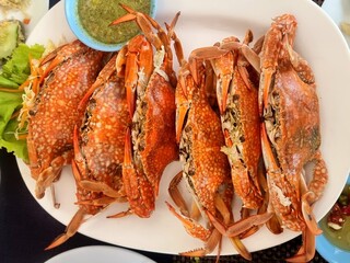 Steamed crab, eaten with seafood sauce (sweet, spicy, sour)