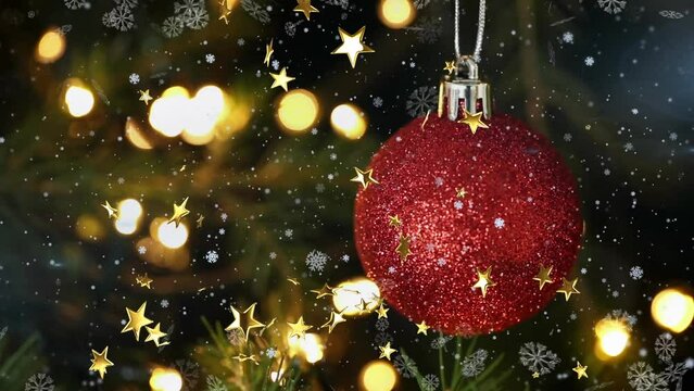 Animation of snow falling over christmas tree with baubles