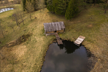 Drone view of old abandoned shack in the middle of forest