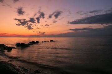 Silhouette of rocks in the sea at dawn, long exposure