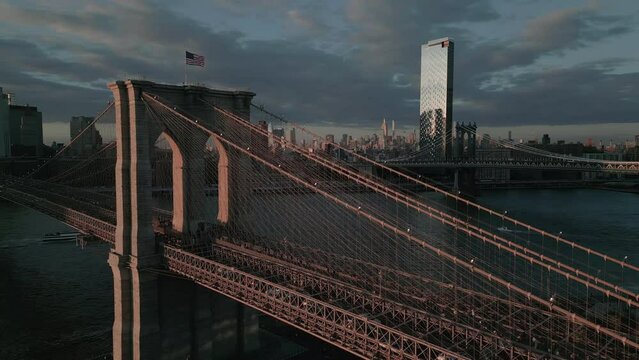 flying clockwise around Brooklyn Bridge at sunset