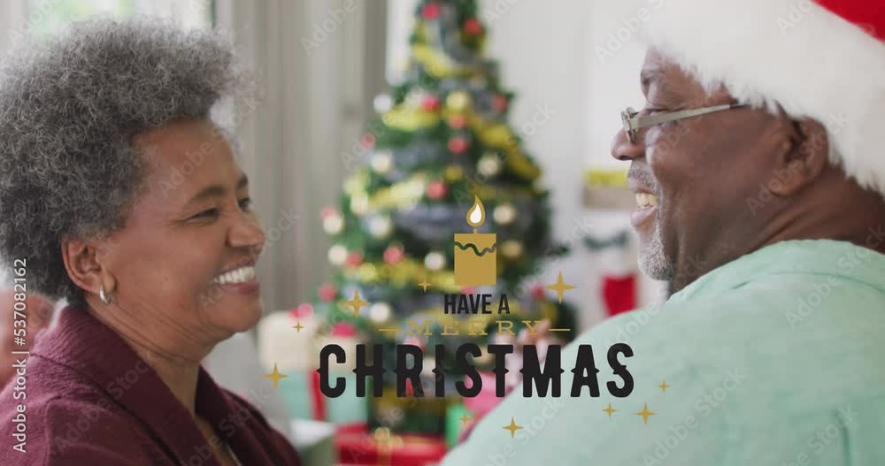 Sticker Animation of christmas greetings text over smiling senior african american couple at christmas