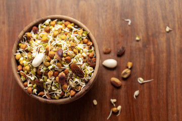Close-up of A mix of organic sprout seeds sprouting ( germinating) bowl contains almond, groundnut,...